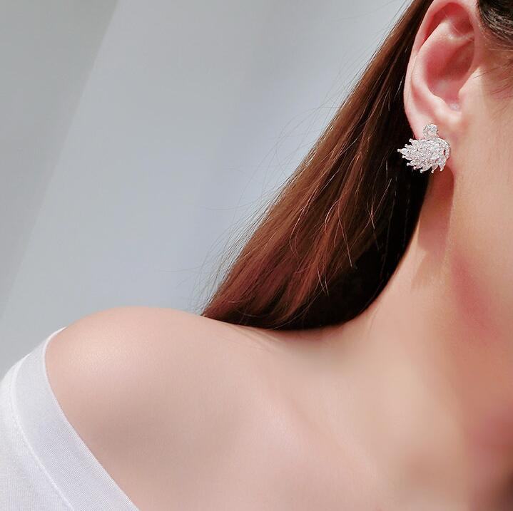 Swan Crystal Earrings with sparkling cubic zirconia, showcasing elegant swan design, worn by a woman.