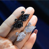 Swan Crystal Earrings showcased in black and white crystal designs, featuring sparkling cubic zirconia stones.