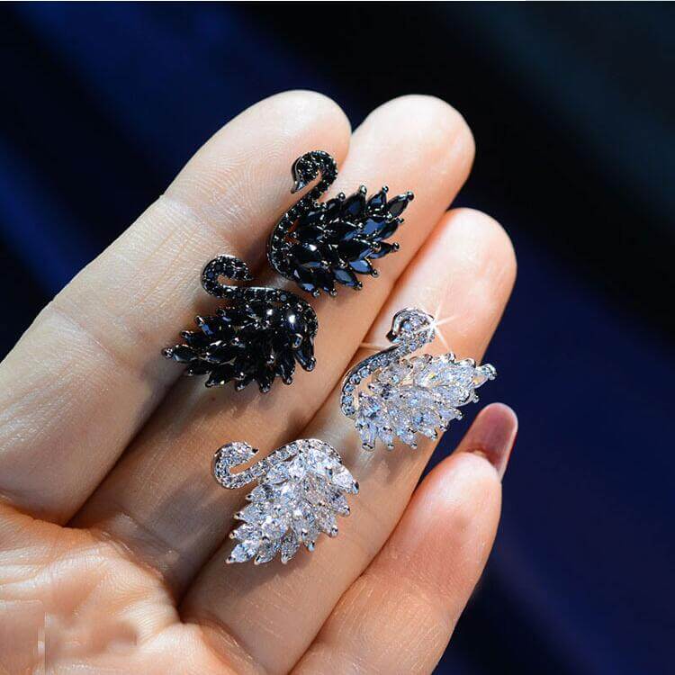 Swan Crystal Earrings showcased in black and white crystal designs, featuring sparkling cubic zirconia stones.