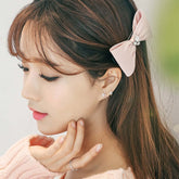 Short Hair Earrings worn by a woman with a pink bow hair accessory, showcasing elegant flower stud jewelry.
